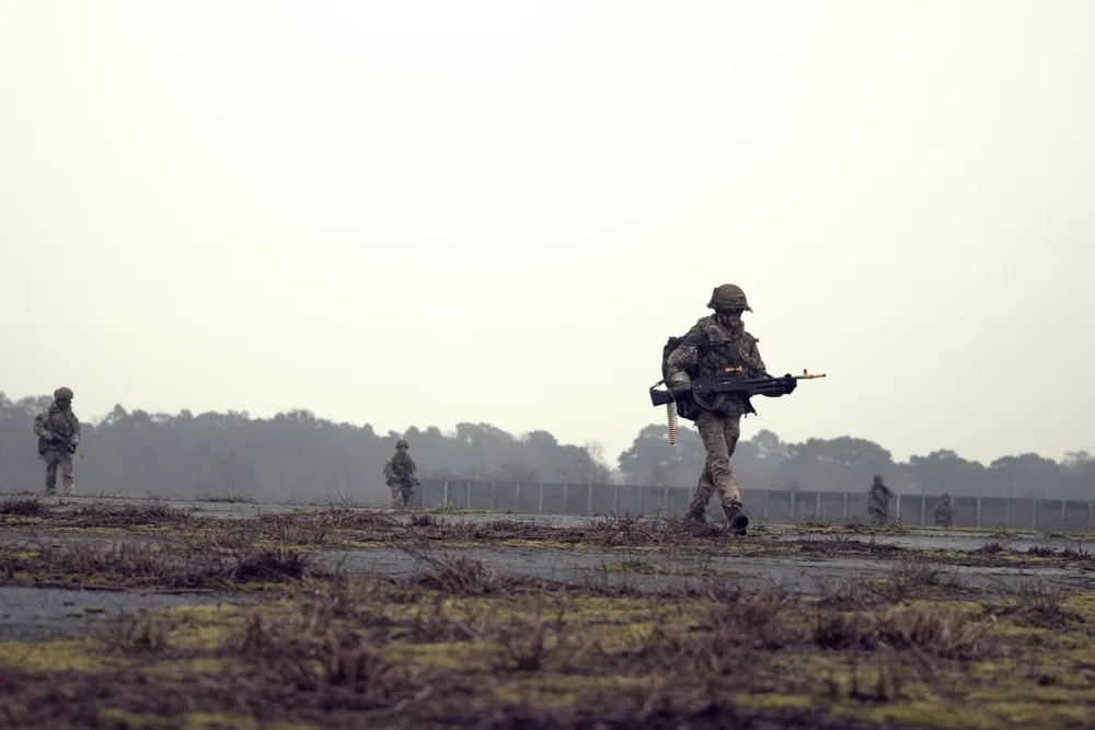 Soldiers moving across open training ground