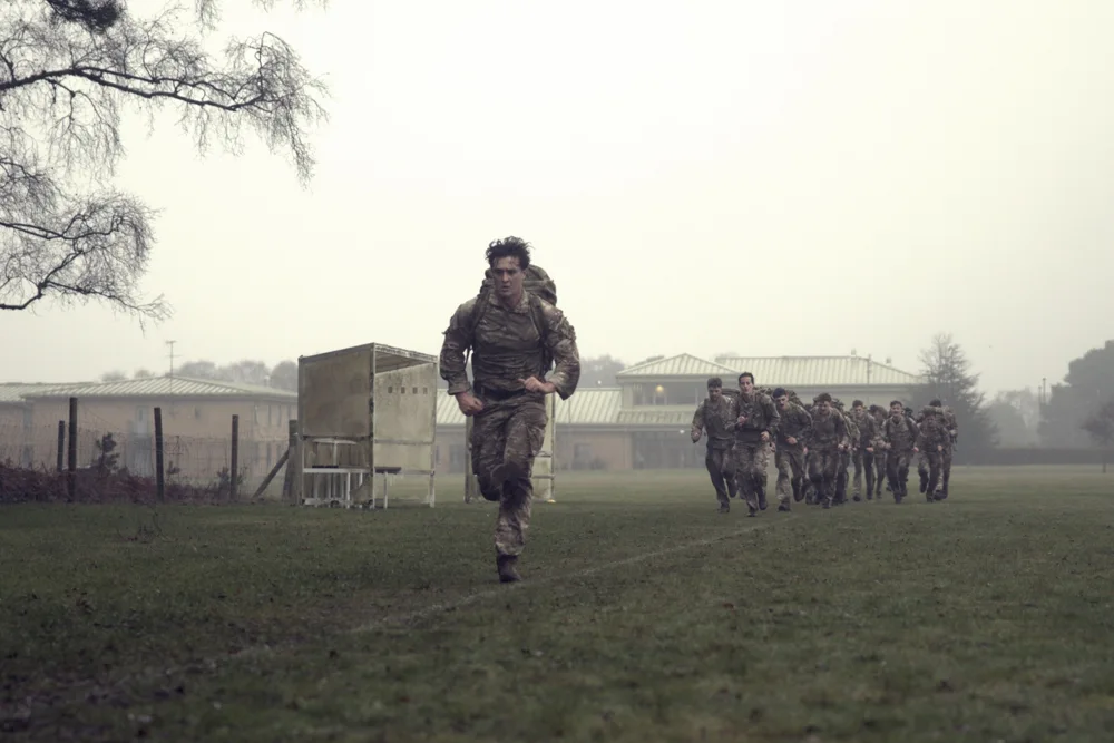 Soldier leading a group across a field
