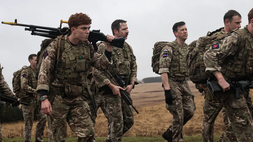 Soldiers carrying equipment together