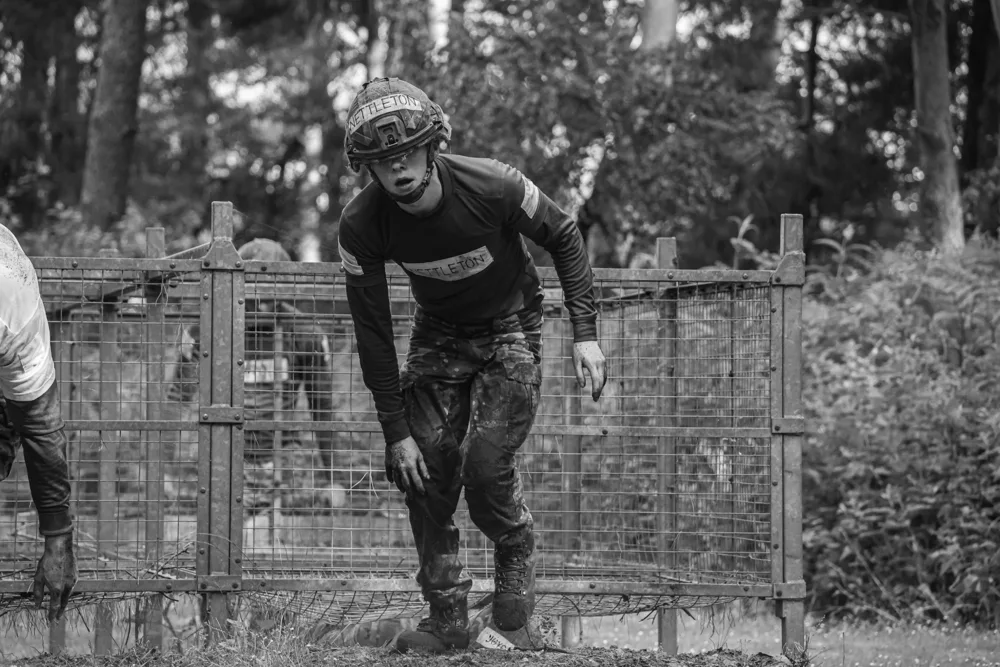Soldier climbing over a training obstacle
