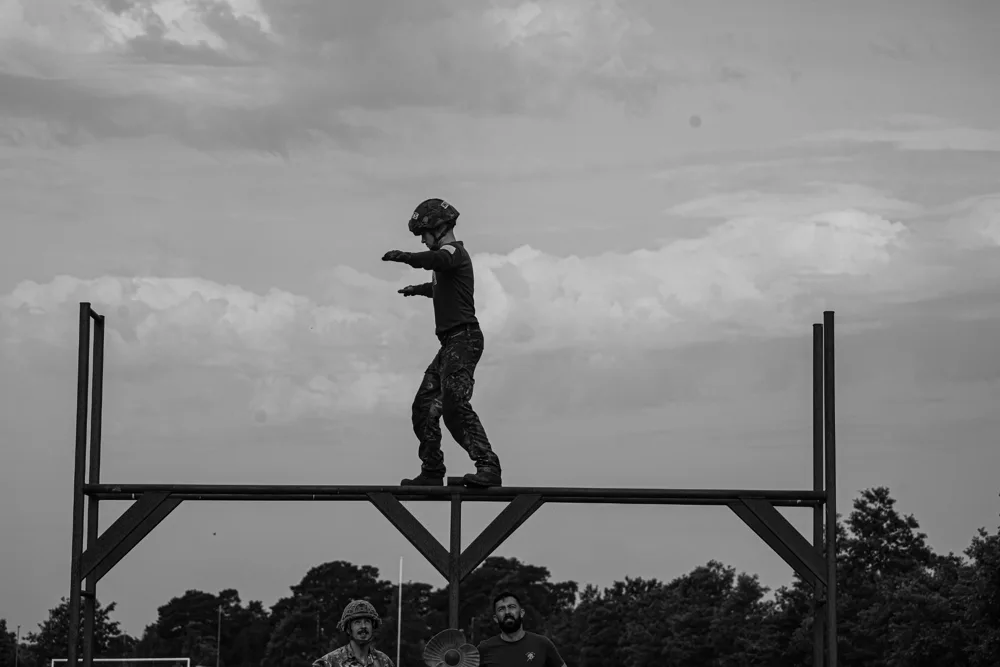 Soldier crossing a raised balance obstacle