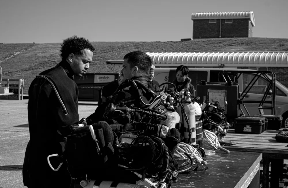 Divers preparing equipment at the waterside