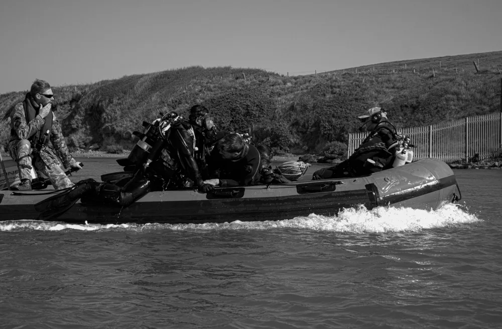 Dive team travelling across the water in a boat