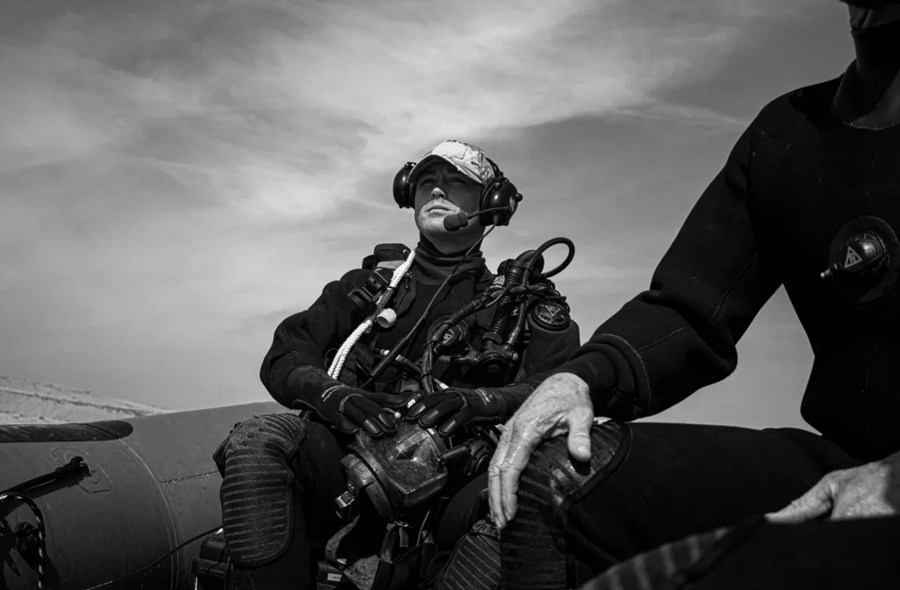 Diver wearing a mask and breathing apparatus on a boat